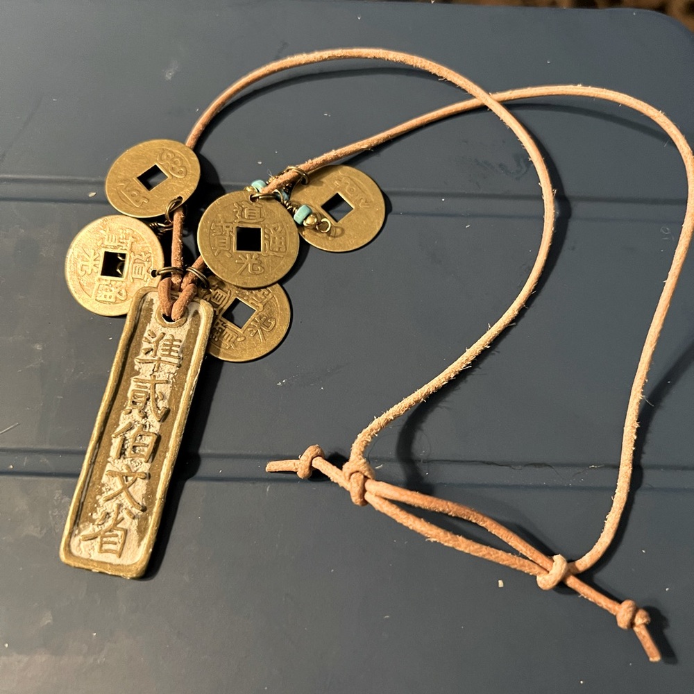 Leather and copper coin necklace, 20-22” length. Small turquoise beads.
Chinese